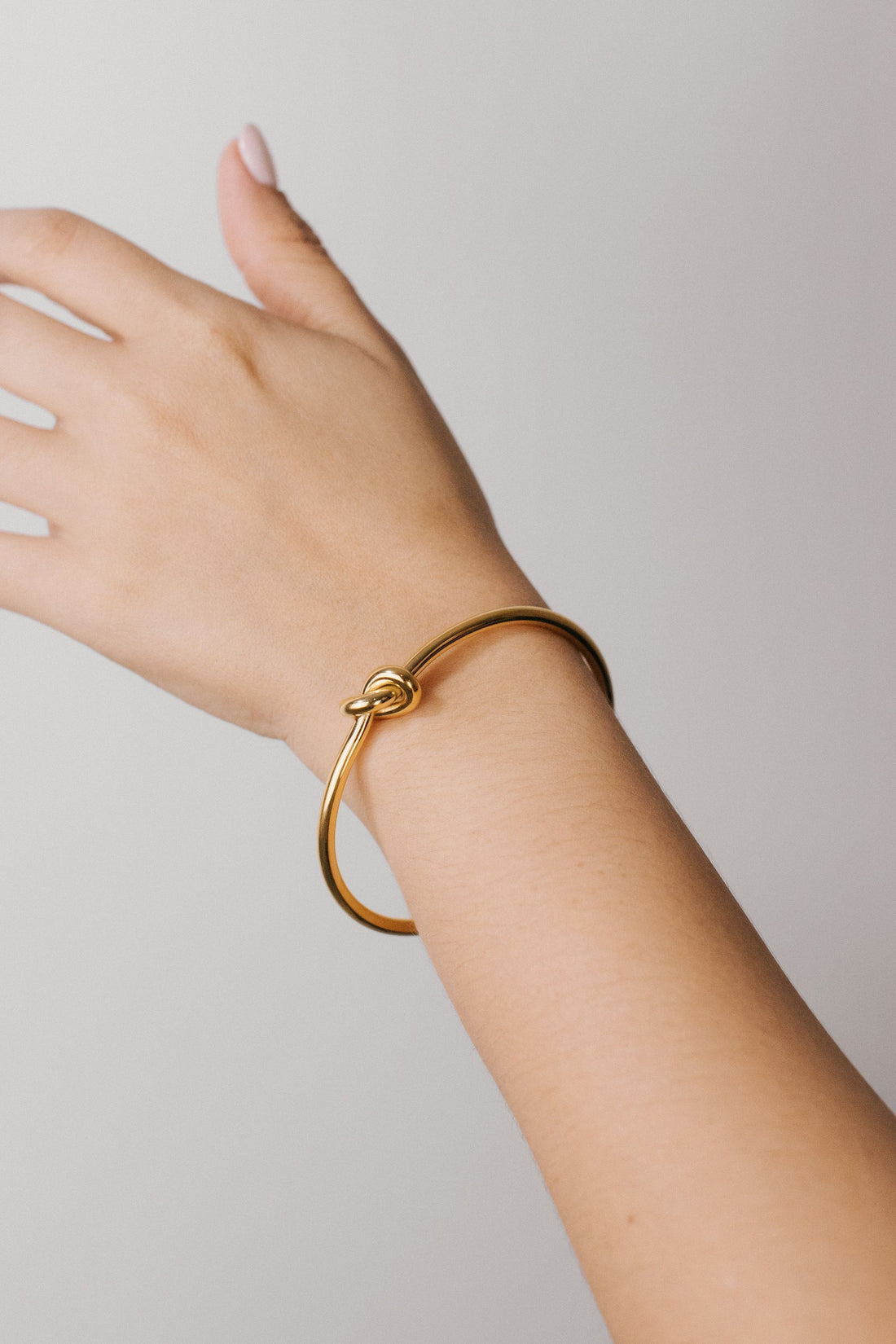 Close-up of a gold bracelet resting on a wrist